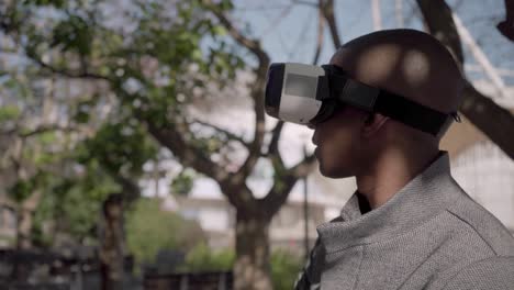 Young-man-using-virtual-reality-glasses-on-street